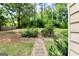 Landscaped backyard with stone path and trees at 4335 Burgomeister Pl, Snellville, GA 30039