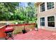 Red deck with grill and wooded backyard view at 4335 Burgomeister Pl, Snellville, GA 30039