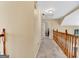 Upstairs hallway with carpeted floor and wooden railing at 4335 Burgomeister Pl, Snellville, GA 30039