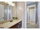 Bathroom boasts granite countertop, dark wood cabinets, and a large mirror at 1689 Nebo Rd, Dallas, GA 30157