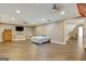 Large bedroom with hardwood floors, ceiling fan, and access to another room at 1689 Nebo Rd, Dallas, GA 30157