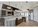 Open kitchen with a farmhouse sink, stainless steel appliances, and hardwood floors at 1689 Nebo Rd, Dallas, GA 30157