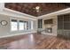 Spacious living room features hardwood floors, a stone fireplace, and a coffered ceiling at 1689 Nebo Rd, Dallas, GA 30157