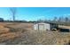 Metal storage building with a small excavator nearby at 1689 Nebo Rd, Dallas, GA 30157