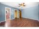 Bedroom with wood floors, ceiling fan, and en-suite bathroom at 241 Simon Ter, Atlanta, GA 30338