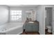 Bathroom with corner tub, vanity, and toilet at 625 Armitage Way, Stockbridge, GA 30281
