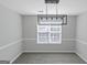 Bright dining room features a modern chandelier and neutral wall colors at 625 Armitage Way, Stockbridge, GA 30281