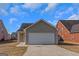 Tan colored garage with white door and concrete driveway at 625 Armitage Way, Stockbridge, GA 30281