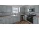 Renovated kitchen with light gray cabinets and stainless steel appliances at 625 Armitage Way, Stockbridge, GA 30281