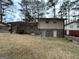 Brick house back with two exterior basement doors and a large yard at 3780 Cedar Hurst Way, South Fulton, GA 30349