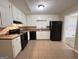Galley kitchen with white cabinets and black appliances at 3780 Cedar Hurst Way, South Fulton, GA 30349