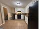 Galley kitchen with white cabinets and black appliances at 3780 Cedar Hurst Way, South Fulton, GA 30349