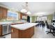 Open kitchen with island, breakfast area, and lots of natural light at 295 W 5 Hwy, Roopville, GA 30170