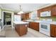 Bright kitchen boasts an island, white appliances, and wood cabinets at 295 W 5 Hwy, Roopville, GA 30170