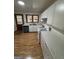 Kitchen with white cabinets, hardwood floors, and appliances at 1037 Dixie Dr, Jonesboro, GA 30236