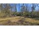 Large backyard with mature trees and open grassy area at 6665 Cedar Hurst Trl, College Park, GA 30349