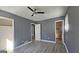 Primary bedroom with gray walls, ceiling fan, and access to bathroom at 6665 Cedar Hurst Trl, College Park, GA 30349