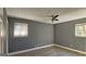 Bedroom with gray walls, ceiling fan, and wood-look flooring at 6665 Cedar Hurst Trl, College Park, GA 30349