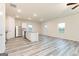 Open concept kitchen with island, stainless steel appliances, and light wood flooring at 450 Prescott Way, Villa Rica, GA 30180