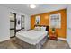 Basement bedroom with orange accent wall and king bed at 1081 Veltre Sw Cir, Atlanta, GA 30311