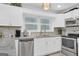 Bright kitchen featuring white cabinets and mosaic backsplash at 1081 Veltre Sw Cir, Atlanta, GA 30311