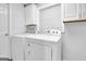 Functional laundry room with side-by-side washer and dryer at 1081 Veltre Sw Cir, Atlanta, GA 30311