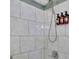 Clean shower with marble tile and modern fixtures at 1081 Veltre Sw Cir, Atlanta, GA 30311