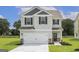 Two-story house with gray siding, white garage door, and landscaped lawn at 431 Prescott Way, Villa Rica, GA 30180