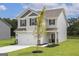 Two-story house with gray siding, white garage door, and a tree in the front yard at 431 Prescott Way, Villa Rica, GA 30180