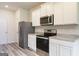 Stainless steel appliances and granite countertops in a bright kitchen at 458 Prescott Way, Villa Rica, GA 30180