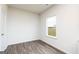 Bright bedroom with hardwood floors and a large window at 435 Prescott Way, Villa Rica, GA 30180