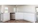 White kitchen cabinetry with granite countertops and stainless steel appliances at 445 Prescott Way, Villa Rica, GA 30180