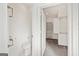 Small bathroom with toilet and access to closet at 8445 Nolandwood Ln, Villa Rica, GA 30180