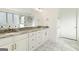 Double vanity bathroom with granite countertops and marble floors at 8445 Nolandwood Ln, Villa Rica, GA 30180