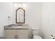 Elegant bathroom with granite vanity and ornate mirror at 8445 Nolandwood Ln, Villa Rica, GA 30180