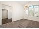 Bright dining room with large window, chandelier, and carpet at 8445 Nolandwood Ln, Villa Rica, GA 30180