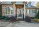 Inviting entryway with stone accents, a dark door, and landscaping at 8445 Nolandwood Ln, Villa Rica, GA 30180