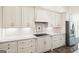 Modern kitchen with white cabinets, granite countertops, and stainless steel appliances at 8445 Nolandwood Ln, Villa Rica, GA 30180