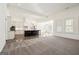 Open concept kitchen with island, white cabinets, and dark floor at 8445 Nolandwood Ln, Villa Rica, GA 30180