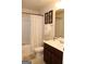 Full bathroom with tub shower and dark vanity at 12298 Centerra Dr, Hampton, GA 30228