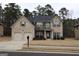 Two-story brick home with a large front yard and two-car garage at 12298 Centerra Dr, Hampton, GA 30228