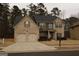 Two-story brick home with a large front yard and two-car garage at 12298 Centerra Dr, Hampton, GA 30228