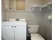 Small bathroom with white vanity, toilet and shelving at 5157 West Nw St, Covington, GA 30014