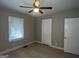 Well-lit bedroom featuring a closet and ceiling fan at 5157 West Nw St, Covington, GA 30014