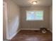 Bright dining room with large windows and wood-look floors at 5157 West Nw St, Covington, GA 30014