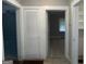 Hallway with access to bedrooms and laundry closet at 5157 West Nw St, Covington, GA 30014