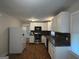 Modern kitchen with white cabinets, stainless steel appliances, and dark countertops at 5157 West Nw St, Covington, GA 30014