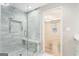 Spa-like bathroom with walk-in shower, marble tile, and built-in seat at 3199 Mcafee Rd, Decatur, GA 30032