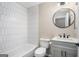Bathroom with hexagon tile, gray vanity, and a round mirror at 3199 Mcafee Rd, Decatur, GA 30032