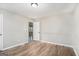 Bright bedroom with hardwood floors and an open door to another room at 3199 Mcafee Rd, Decatur, GA 30032